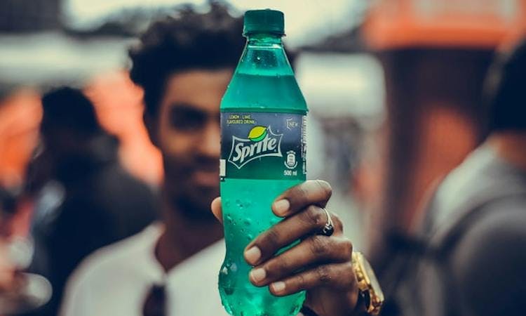Person holding Sprite bottle