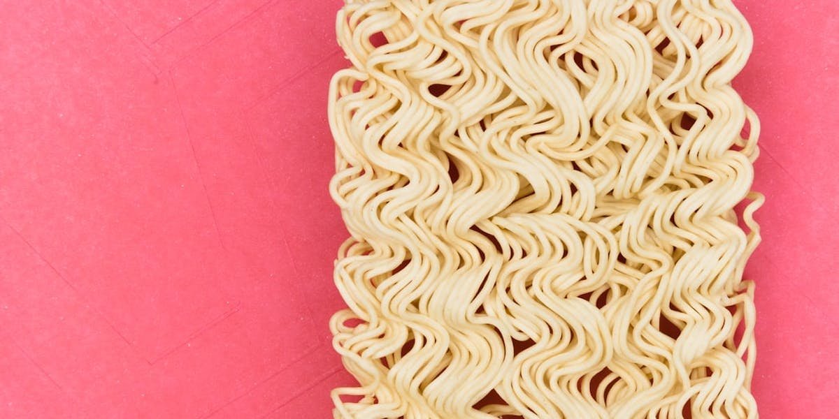instant noodles on pink background