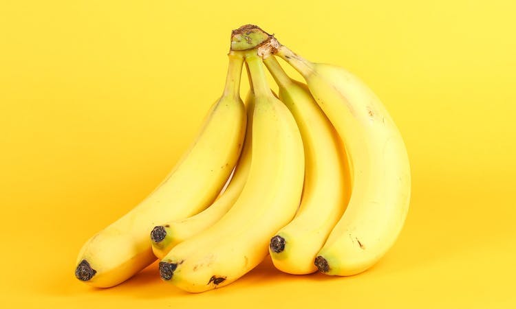 bunch of bananas on a yellow background 