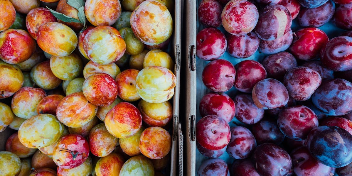 plums in crates
