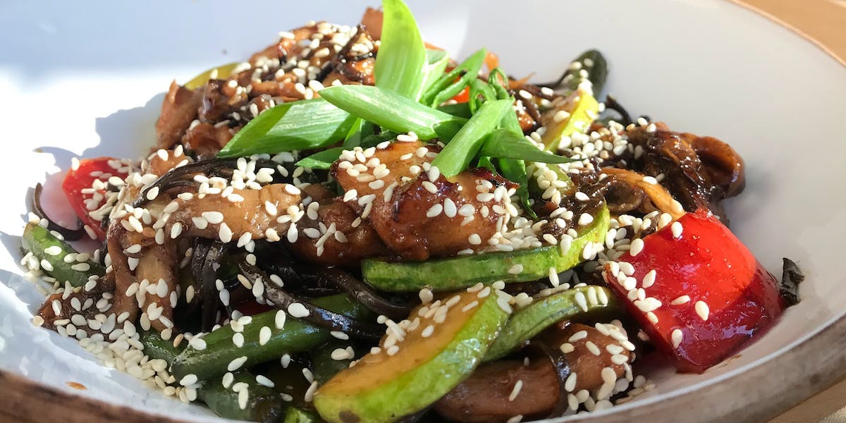 a stir-fry covered in sesame seeds