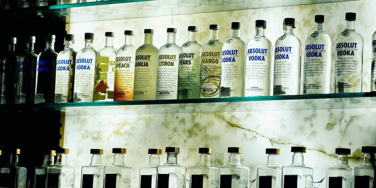 a shelf of vodka bottles
