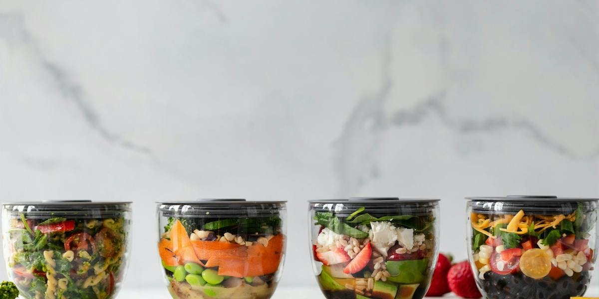 salads in four food containers