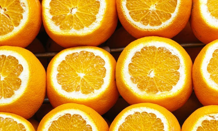 Rows of oranges with tops sliced open