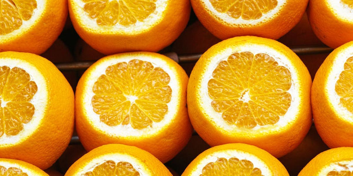 Rows of oranges with tops sliced open
