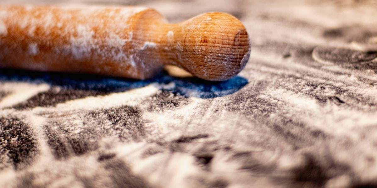 flour on surface with rolling pin