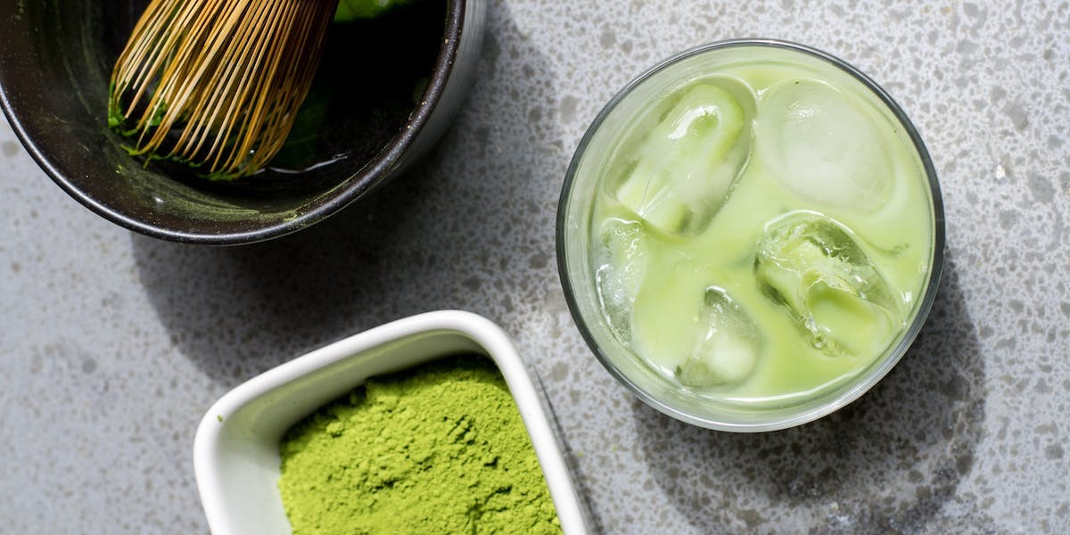 matcha powder with whisk and matcha drink