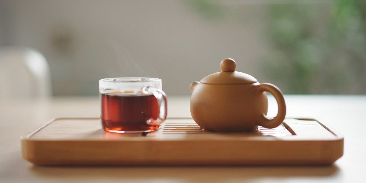 a cup of tea and a tea pot