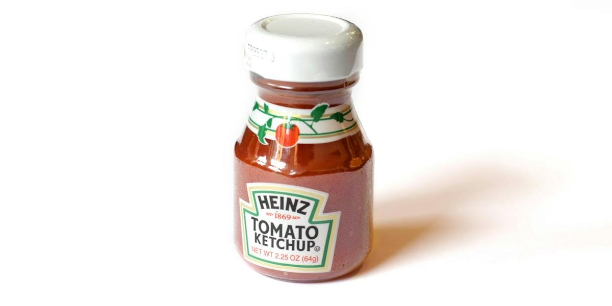 a very small bottle of heinz ketchup