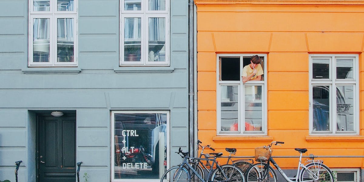 Bikes outside bright coloured apartments in Copenhagen