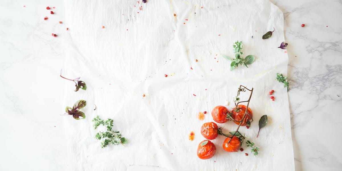 tomatoes on vine on white cloth