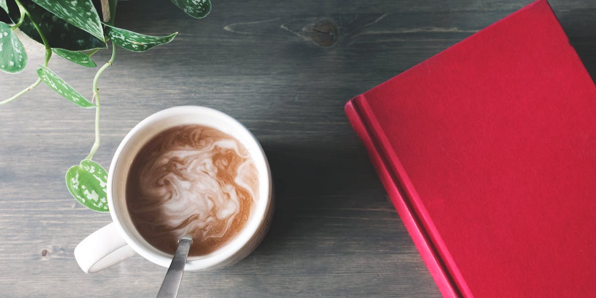 hot chocolate next to red book