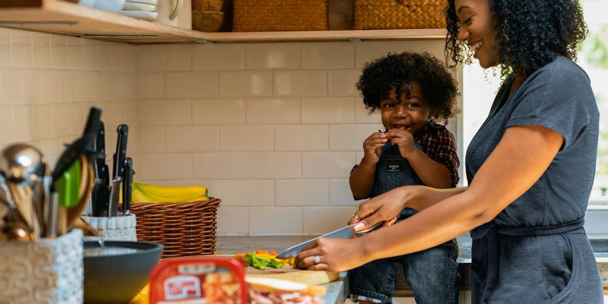 woman making food with child