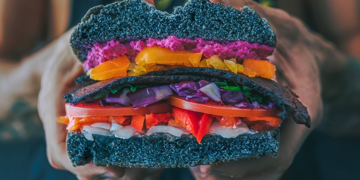 vegan sandwich held to. camera