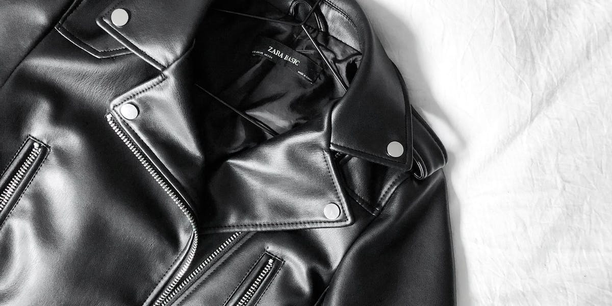 a leather jacket on a coat hanger 