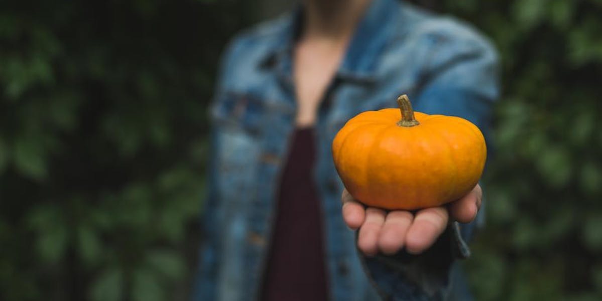 woman holding small pumpkin
