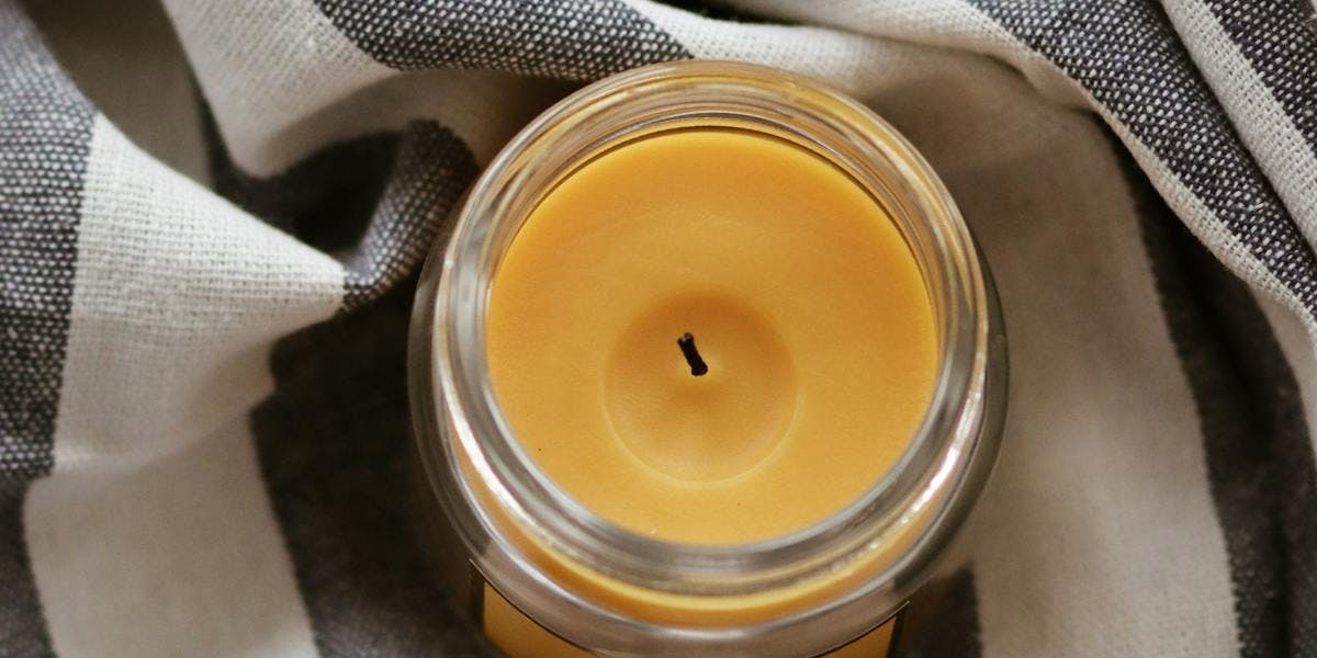 candle on striped sheet