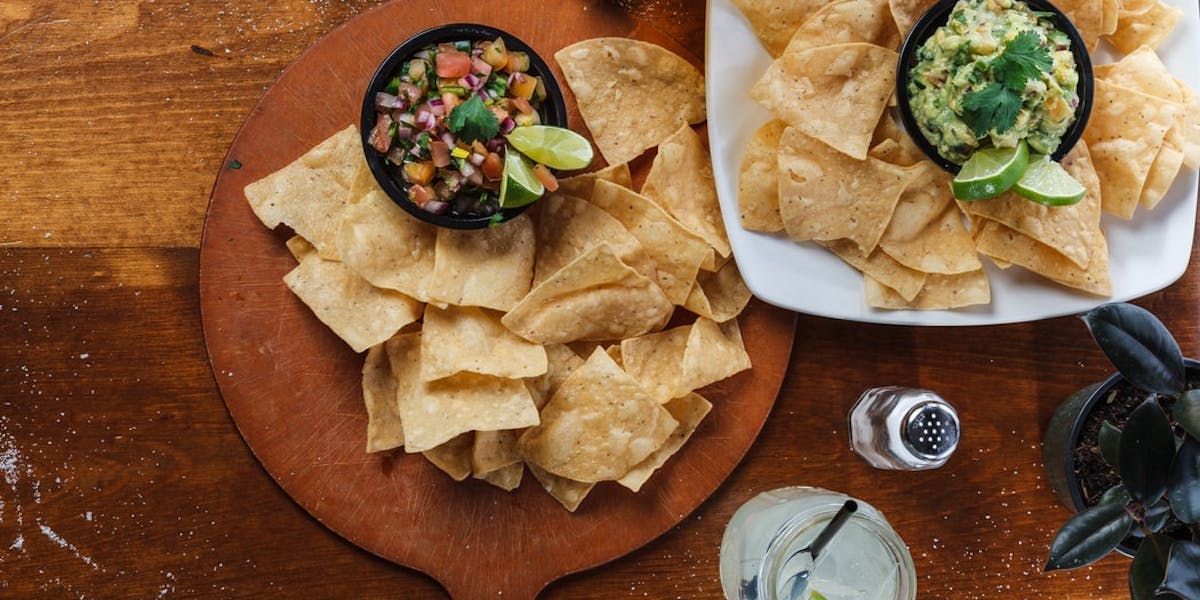 platter of tortilla chips with dip