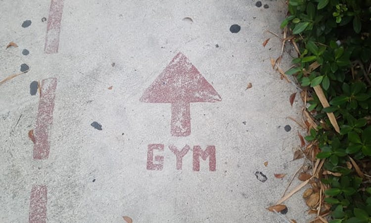 gym sign on the floor with an arrow