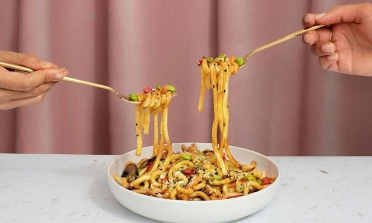 two forks sharing noodles 