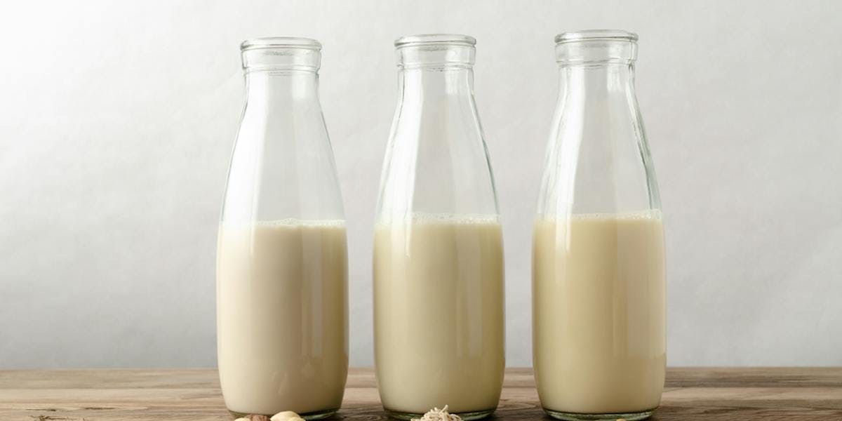 Glass milk bottles on table 